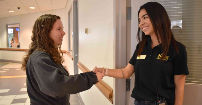 event assistant meets with a client outside an event space