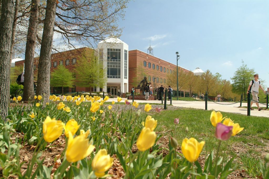 A photo of the Johnson Center with flowers in front