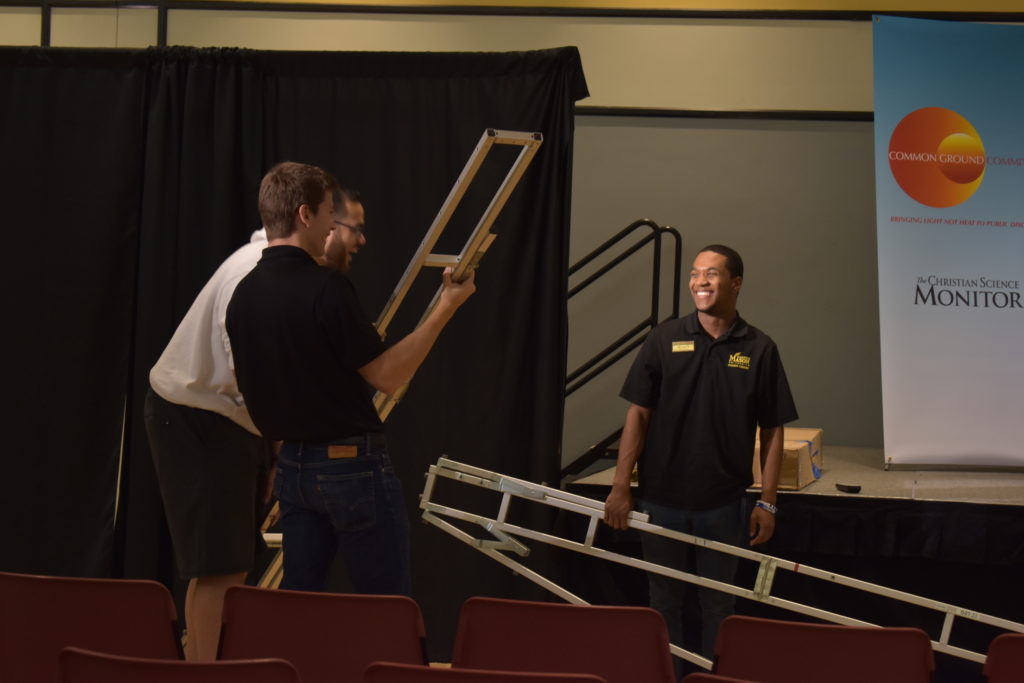 students carrying equipment to setup